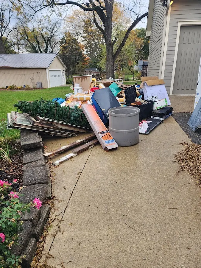 Dumpster being loaded with debris for 12 Yard Dumpster Rental in Tucson Estates